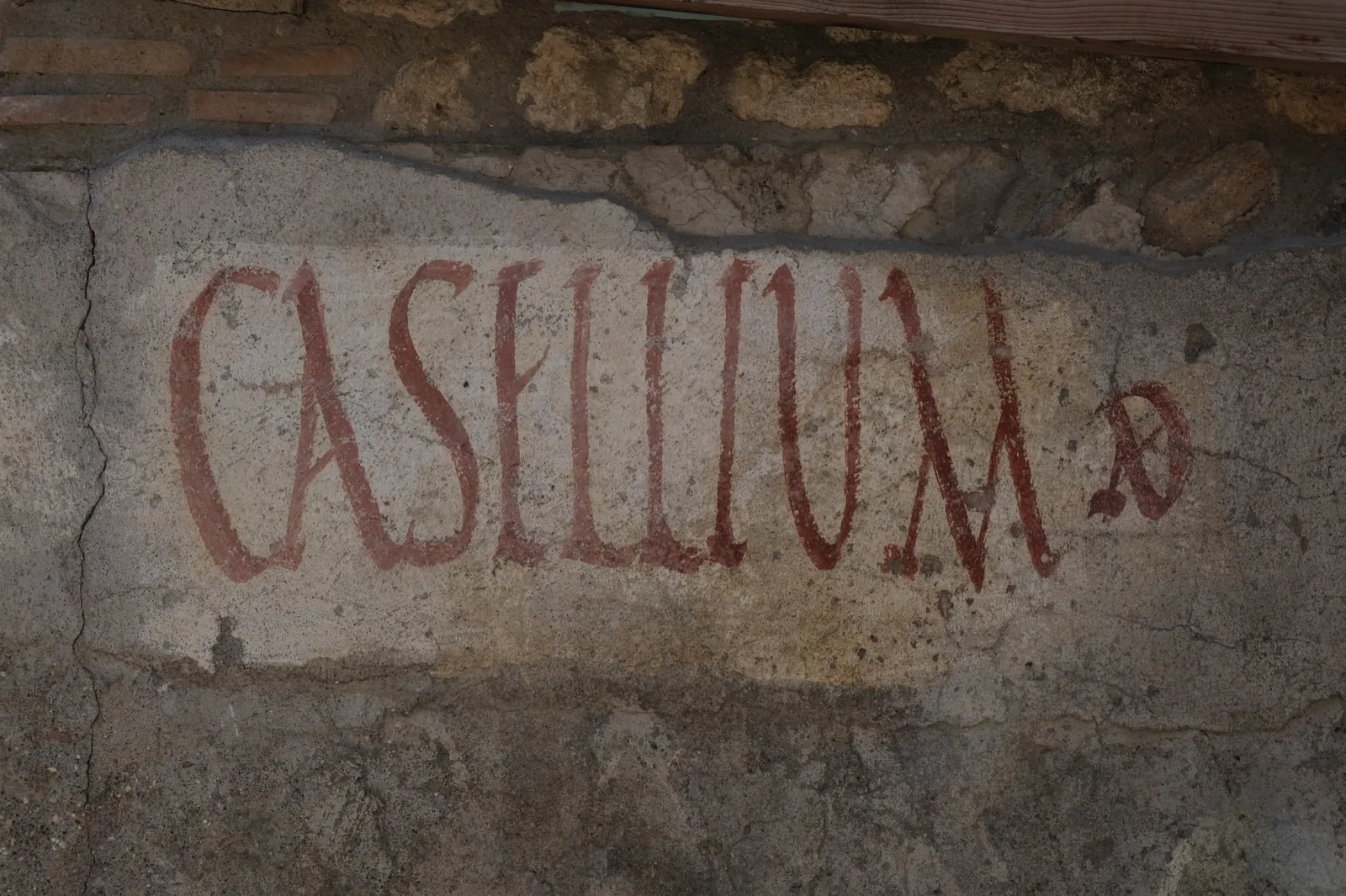 Painted CASELLIUM inscription on a wall in Pompeii
